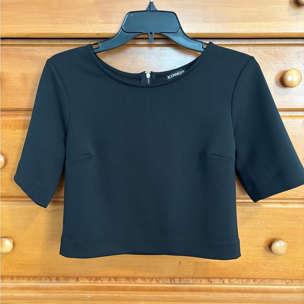 Express fitted black crop top with gold zipper detail.
